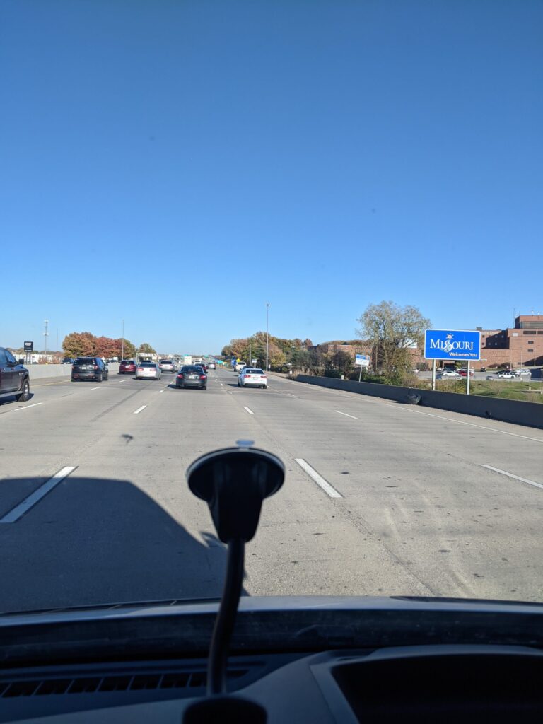 Driving down the freeway with the Missouri state welcome sign in view
